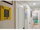Hallway featuring white doors, baseboards, and accent decor on the wall at 8795 56Th N St, Pinellas Park, FL 33782