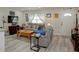 Cozy living room featuring wood-look floors, a comfortable gray sofa, and lots of natural light at 8795 56Th N St, Pinellas Park, FL 33782