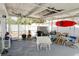 Enclosed patio with fishing rods hanging from the ceiling, a grill, shed, and a red kayak at 8795 56Th N St, Pinellas Park, FL 33782