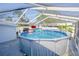 Backyard view of above ground pool with an enclosure, yard, and pool float at 8795 56Th N St, Pinellas Park, FL 33782