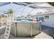 Backyard view of the above ground pool with a pool ladder under a screened in enclosure at 8795 56Th N St, Pinellas Park, FL 33782