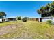 Spacious backyard featuring a shed, partial fence and ample room for gardening or outdoor activities at 899 S Broadway, Englewood, FL 34223