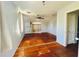 Spacious bedroom with hardwood floors, a ceiling fan, and a window with curtains at 899 S Broadway, Englewood, FL 34223