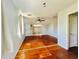 Bright bedroom featuring hardwood floors, a ceiling fan, and natural light through the window at 899 S Broadway, Englewood, FL 34223