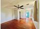 Bedroom with a ceiling fan and hardwood floors, leading to an adjacent room at 899 S Broadway, Englewood, FL 34223