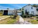Exterior view of a home with a detached garage and ample yard space at 899 S Broadway, Englewood, FL 34223