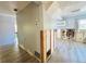 Hallway leading to living area and kitchen with unfinished wall and wood-look tile at 899 S Broadway, Englewood, FL 34223