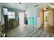 Partially renovated kitchen with wood look tile, open walls, and updated plumbing and electric at 899 S Broadway, Englewood, FL 34223