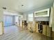 Partially renovated kitchen with wood look tile, open walls, and updated plumbing and electric at 899 S Broadway, Englewood, FL 34223
