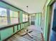 Renovation of living room with exposed framing, walls, and a front entrance at 899 S Broadway, Englewood, FL 34223