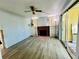 Living area with wood look tile, a fireplace, built-in shelving, and sliding glass doors at 899 S Broadway, Englewood, FL 34223