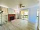 Bright living area with wood look tile, a fireplace, built-in shelving, and sliding glass doors at 899 S Broadway, Englewood, FL 34223