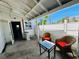 Outdoor area featuring two wicker chairs with bright pillows and outdoor access to the backyard at 899 S Broadway, Englewood, FL 34223