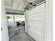 Outdoor patio featuring two wicker chairs, concrete floors and ample natural light and access to the backyard at 899 S Broadway, Englewood, FL 34223