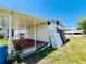 A covered porch adds to the charm of this home, providing a spot for relaxation at 899 S Broadway, Englewood, FL 34223