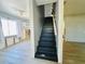 Stairway featuring black painted steps with access to spaces under renovation at 899 S Broadway, Englewood, FL 34223