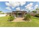 Well-maintained backyard featuring a pergola, seating area, and lush landscaping at 949 Springview Nw Ave, Port Charlotte, FL 33948