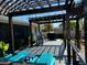 Back deck features a pergola, backyard view, and brightly colored furniture at 949 Springview Nw Ave, Port Charlotte, FL 33948