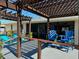 Back deck with pergola, bright seating, and view of well-kept backyard at 949 Springview Nw Ave, Port Charlotte, FL 33948
