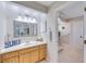 Bathroom with white countertops, wood cabinetry, coastal decor, and a view into the toilet area at 949 Springview Nw Ave, Port Charlotte, FL 33948