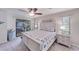 Comfortable bedroom features coastal décor, carpet flooring, and access to a screened lanai at 949 Springview Nw Ave, Port Charlotte, FL 33948