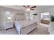 Cozy bedroom with nautical decor, a ceiling fan, and a view into the bathroom at 949 Springview Nw Ave, Port Charlotte, FL 33948
