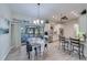 Light-filled dining room with a chandelier, a sliding glass door, and a view of the kitchen and outdoor area at 949 Springview Nw Ave, Port Charlotte, FL 33948