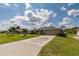 Single Gathering home with a long driveway and landscaping, perfect for outdoor living at 949 Springview Nw Ave, Port Charlotte, FL 33948