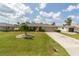 Single Gathering home with well-manicured lawn and beautiful landscaping at 949 Springview Nw Ave, Port Charlotte, FL 33948