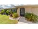 Inviting front entrance with lush landscaping and a well-manicured lawn at 949 Springview Nw Ave, Port Charlotte, FL 33948