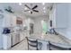 Bright kitchen features granite counters, stainless steel appliances, and white cabinets with seamless access to other living areas at 949 Springview Nw Ave, Port Charlotte, FL 33948
