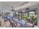 Screened patio with a ceiling fan, decorative furniture, and ample seating for comfortable outdoor enjoyment at 949 Springview Nw Ave, Port Charlotte, FL 33948