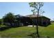 Well-manicured backyard featuring a screened-in lanai, mature landscaping, and a serene outdoor space at 98 Valdiva St, Punta Gorda, FL 33983