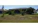 Large, open backyard with a spacious screened-in patio, providing privacy and space for outdoor enjoyment at 98 Valdiva St, Punta Gorda, FL 33983