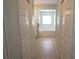 Bright bathroom featuring a large soaking tub, tiled floors, and access to closet space at 98 Valdiva St, Punta Gorda, FL 33983