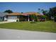 Charming home with lush landscaping, a well-maintained lawn, and an inviting curb appeal at 98 Valdiva St, Punta Gorda, FL 33983