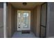 Close-up of the front door with decorative glass, sidelight, and a welcoming doormat at 98 Valdiva St, Punta Gorda, FL 33983