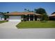 Well-maintained one-story home featuring a two-car garage, landscaping, and a manicured lawn at 98 Valdiva St, Punta Gorda, FL 33983