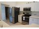 Modern kitchen with stainless steel appliances, sleek cabinetry, and a convenient breakfast bar at 98 Valdiva St, Punta Gorda, FL 33983