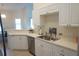 Modern kitchen with stainless steel appliances, sleek cabinetry, and a convenient breakfast bar at 98 Valdiva St, Punta Gorda, FL 33983