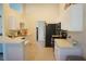 Bright kitchen featuring white cabinets, stainless steel appliances, and an open counter space at 98 Valdiva St, Punta Gorda, FL 33983
