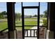 View from the screened-in porch showcasing the front yard and neighborhood at 98 Valdiva St, Punta Gorda, FL 33983