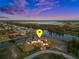 Sunset aerial view highlighting the waterfront property, dock, and scenic canal at 10580 Poughkeepsie Cir, Port Charlotte, FL 33981
