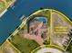 Luxury waterfront estate featuring a pool, boat dock, and adjacent vacant lot at 10580 Poughkeepsie Cir, Port Charlotte, FL 33981