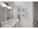 Bright and airy bathroom featuring a double vanity, soaking tub, walk-in shower, and tile flooring at 10580 Poughkeepsie Cir, Port Charlotte, FL 33981