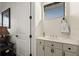 Bright half-bathroom featuring a white vanity, modern fixtures, and a stylish mirror at 10580 Poughkeepsie Cir, Port Charlotte, FL 33981