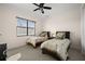 This bedroom features twin beds, a ceiling fan, and natural light from a window at 10580 Poughkeepsie Cir, Port Charlotte, FL 33981