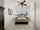 Serene bedroom showcasing a comfortable bed, soft lighting, and tile flooring at 10580 Poughkeepsie Cir, Port Charlotte, FL 33981