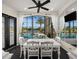 Cozy dining area with a view of the pool, modern furniture, and lots of natural light at 10580 Poughkeepsie Cir, Port Charlotte, FL 33981