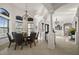 Bright dining room showcasing tile floors, decorative columns, elegant lighting fixtures, and large windows at 10580 Poughkeepsie Cir, Port Charlotte, FL 33981